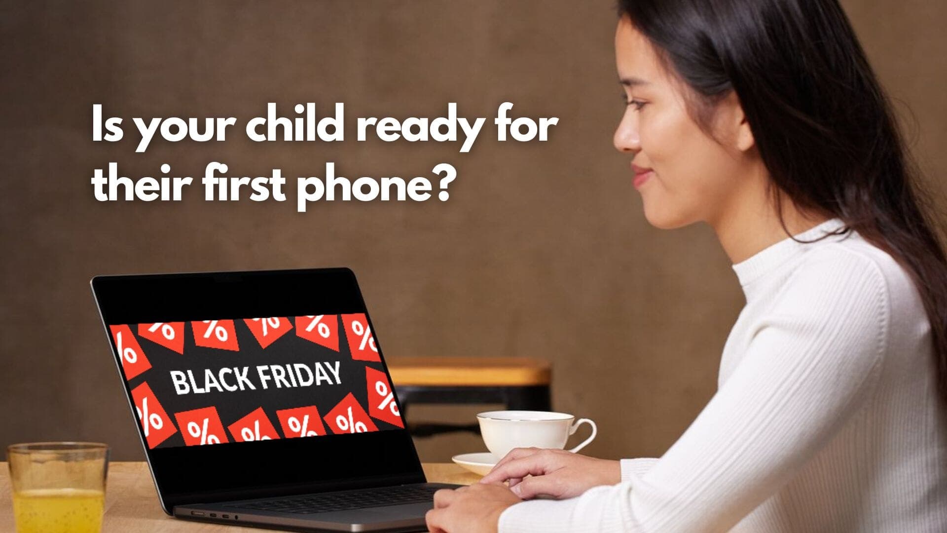 The laptop screen displays a Black Friday with a woman sitting